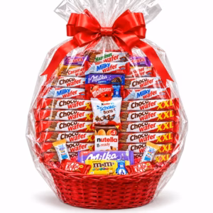 Cesta económica con chocolates Kínder, Milka, Nutella, KitKat y M&M's, envuelta en celofán transparente y decorada con un gran lazo rojo.