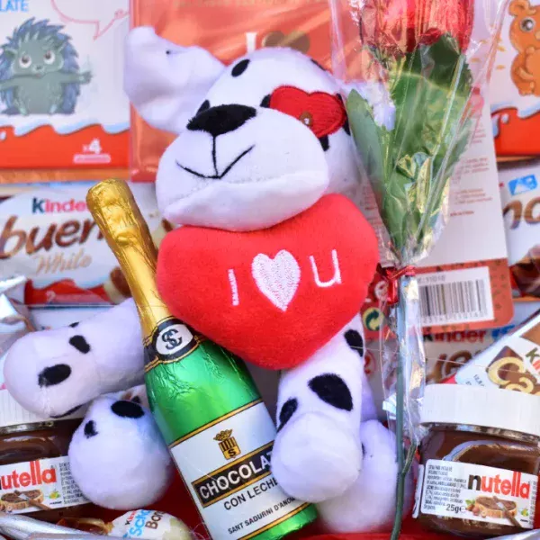 Botella de chocolate y un peluche con rosa de chocolate. Ideal cesta para regalar en San Valentín